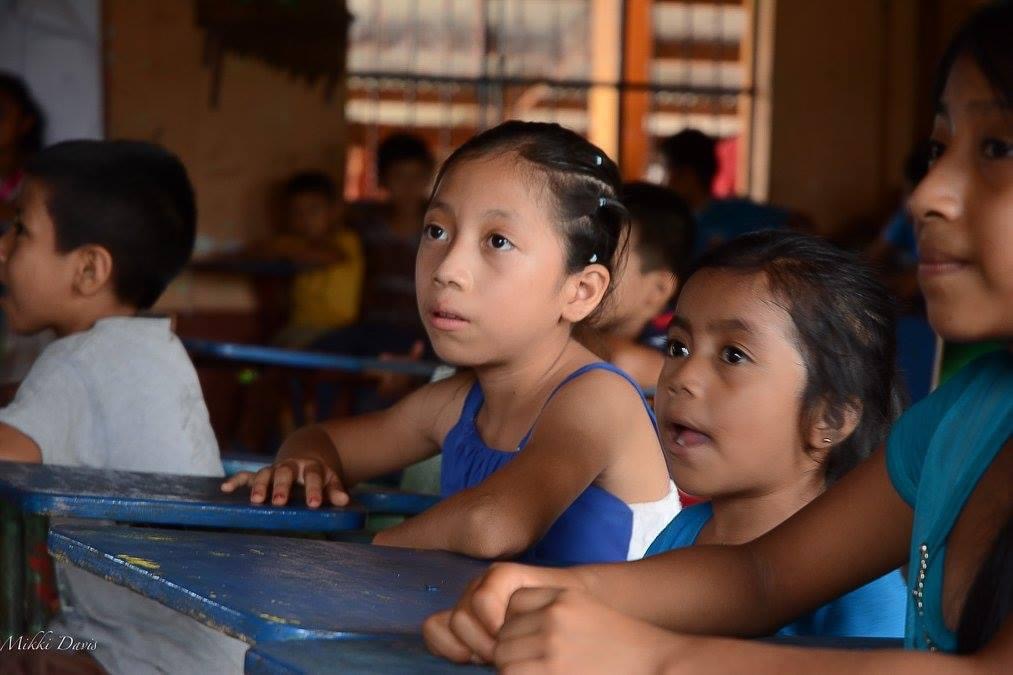 Children learning together at their desks in a rural Guatemalan classroom